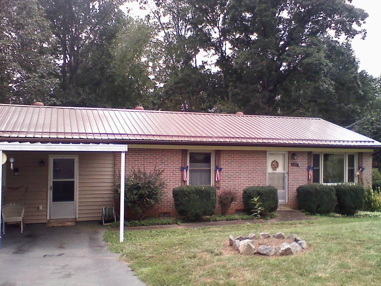Bronze metal roof and carport on a brick ranch home — Roof Repair work by our crew in Westmoreland